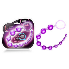 The B Yours - Basic Beads Anal Beads feature purple, beaded silicone with a looped handle, shown next to its packaging. The packaging highlights features such as "I'm easy to hold," "I bend with your body," and "great for beginners." Crafted from flexible jelly and body-safe materials.