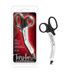 Image of the Temptasia Safety Scissors in black and silver. The packaging showcases the scissors against a red and black gradient background. These stainless steel safety scissors have a blunt tip to protect skin and are designed to cut through ropes and other bondage materials safely.