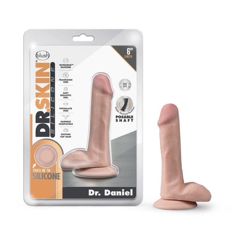 Packaging for the Dr. Skin Silicone "Dr. Daniel" 6-inch realistic dildo by Blush. This body-safe silicone product features a posable shaft and suction cup base, with packaging that highlights qualities like fragrance-free, soft feel, and harness compatibility.