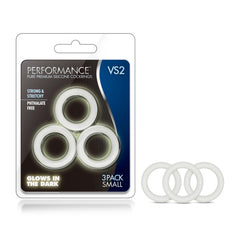 Image of Performance VS2 Pure Premium Silicone Cockrings. The package contains three white cock rings that glow in the dark, noted for being strong, stretchy, and phthalate-free. The rings are displayed outside the package labeled "3 Pack Small.