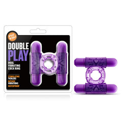 The "Play With Me - Double Play Vibrating Cock Ring" set is displayed. This purple couple's toy features two vibrating parts and stimulating ticklers, boasting intense vibrations and waterproof capabilities as highlighted on the packaging.