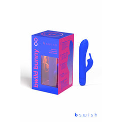 A vibrant Pacific Blue dual motor waterproof vibrator with a rabbit ear design is shown next to its matching packaging. The packaging displays the product name "Bwild Classic Bunny Infinite Limited Edition," a cutout window revealing the toy inside, and the brand logo "bswish" at the top and bottom. Made with body-safe silicone, it features a rechargeable battery for convenience.