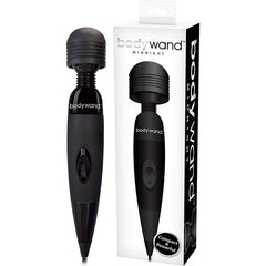 A black Bodywand Midnight Vibrator - Black Mains Powered Massage Wand is displayed next to its packaging box. The box showcases an image of the massager and includes text reading "bodywand MIDNIGHT," emphasizing its "Compact" size, "Powerful" nature, and strong stimulation capabilities. The massager features a rounded head, soft-touch surface, and a single control button.