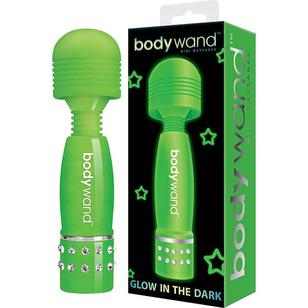 A vivid green, splashproof Bodywand Mini - Glow in Dark Mini Massager Wand Vibrator with a rounded head and jeweled handle, accompanied by its matching packaging. The box boasts green stars against a black background and the text "Bodywand Glow in the Dark." Experience soft-touch comfort combined with powerful stimulation.