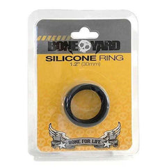 A packaged, black Boneyard Silicone Cock Ring 30mm displayed in a plastic blister pack with a cardboard backing. The packaging reads "Boneyard Silicone Cock Ring 1.2'' (30mm)" and features a winged skull logo with the phrase "Bone for Life" underneath. Made from 100% silicone, this durable man toy offers an impressive 3x stretch.