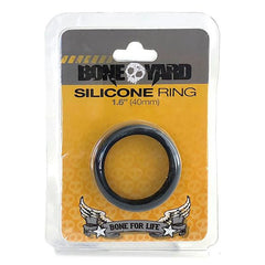 Packaging of the Boneyard Silicone Cock Ring 40mm. The package showcases a black ring against an orange background adorned with skull and wing graphics, alongside the slogan "Bone For Life." Celebrated for its Xtreme durability, this ring belongs to the ultimate collection of man toys.