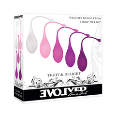 A product box displaying a set of five gradient-colored Kegel balls, varying from light pink to dark purple. The weights, intended to strengthen pelvic floor muscles, range from 1.06oz to 4.1oz and are named "Evolved TIGHT & DELIGHT." Decorative swirls embellish the bottom of the box.