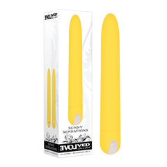 A yellow cylindrical Evolved Sunny Sensations Vibrator next to its retail packaging. The box displays the product image and features such as "Evolved" branding, "Sunny Sensations," and "Silicone - Rechargeable." This classic vibrator boasts a minimalist design with a white base and includes a multi-speed motor for customized pleasure.