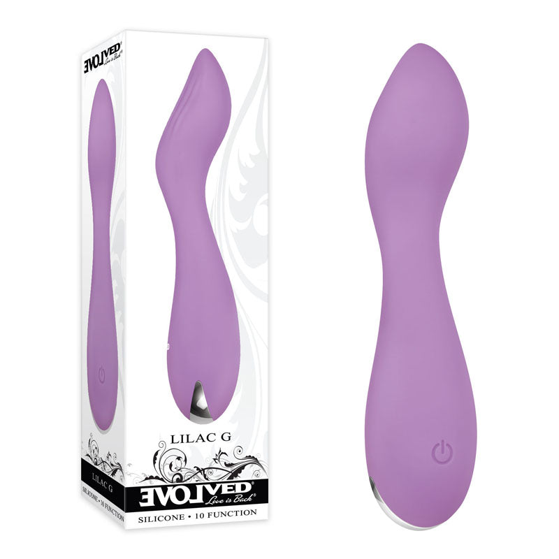 The Evolved LILAC G, a lilac-colored silicone G-Spot vibrator with a curved design, is shown next to its packaging. The box displays an image of the vibrator, the brand name "Evolved," and product details highlighting its 10 powerful vibration functions. This waterproof vibrator features a power button at the base.