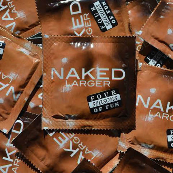 A pile of sleek brown-colored packets labeled "Four Seasons Naked Larger Condoms" and "Four Seasons of Fun" in white and black text. The packets, designed for large penis sizes, are scattered enticingly by Four Seasons Condoms, available in a bulk box of 144.