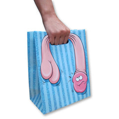 A hand holding a "Floppy Pecker Gift Bag," which features vertical stripes in light blue and a cartoon drawing of male genitalia with googly eyes and a humorous expression.