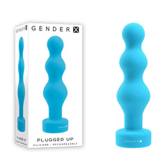 A blue, silicone, three-bulb butt plug with a flat base, displayed next to its white packaging. The packaging features an image of the toy and reads "Gender X PLUGGED UP Vibrating Anal Butt Plug" with the description "Flexible beaded vibrator – Phthalate & latex free silicone – 10 vibrating speeds.