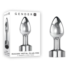 Box and product image of the Gender X ROCKIN METAL PLUG MINI Vibrating Butt Plug, a metallic, vibrating metal plug designed for erotic stimulation. The box features the same device along with text indicating it has 7 speeds/functions and is waterproof & submersible.