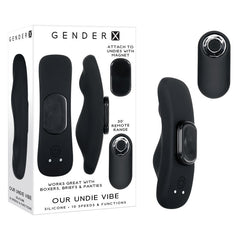 The Gender X OUR UNDIE VIBE Wearable Vibrator is a small black silicone device that is waterproof and submersible. It is shown alongside its packaging, which details 10 powerful vibrating speeds. The vibrator can attach to underwear using a magnet, making it compatible with boxers, briefs, and panties. Additionally, it comes with a remote control that has a range of up to 30 feet.