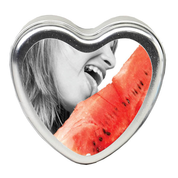A heart-shaped frame holds a black and white photo of a person with their mouth open, seemingly about to enjoy an Edible Watermelon Massage Candle. The focus is on the person's lips savoring the watermelon flavor, creating a vivid contrast with the monochrome background.