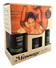 A retail package labeled "Hemp Seed Massage In A Box" contains hemp seed massage products. The packaging features images of a smiling woman receiving a shoulder massage from a man, emphasizing relaxation and wellness. The Guavalava scented products include massage lotion and body oil.