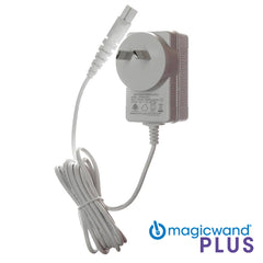Image of a white Magic Wand Plus - Power Cord with an attached power cable. The replacement power supply features a plug, electrical information, and symbols on its front. The text "magicwand PLUS" is at the bottom right corner next to a blue logo.
