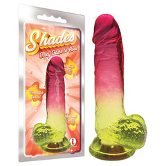 Package and product image of the Shades 8'' Jelly TPR Dong. The jewel-tone dildo transitions from red at the tip to yellow at the base. The packaging features the brand name "Shades" and highlights its gradient color fading, body-safe material, and an "i" icon, emphasizing both safety and style in adult toys.