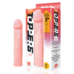 A product image showing The 9's Toppers Penis Extension Sleeve - Flesh for augmenting length by 3 inches. The flesh-colored sleeve, crafted from body-safe material, is displayed alongside its packaging which highlights its stretchable, waterproof qualities and easy-to-clean features. Packaging shows an "actual size" label at 7.5 inches.