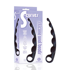 A black silicone anal beads toy is displayed next to its packaging, which reads "The 9's S-Curves Anal Beads, Medical Grade Silicone, Ultra Smooth, Tapered for Your Pleasure, Easy Pull Handle, Ideal for Beginners." The toy features several rounded pleasure-bumps.