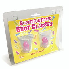 Packaging includes two clear plastic shot glasses with pink penis-shaped objects inside. The yellow background showcases the product name "Super Fun Penis Shot Glasses - Set of 2" in pink and purple text, along with colorful penis-shaped illustrations. Text at the bottom says "Gulp it Down!" Perfect for your party goods!