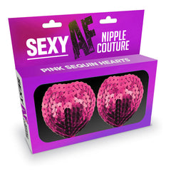 The purple packaging contains two pink sequin heart-shaped nipple covers, prominently displaying the brand name "Sexy AF" and product name "Nipple Couture Pink Hearts" to showcase their trendy design.
