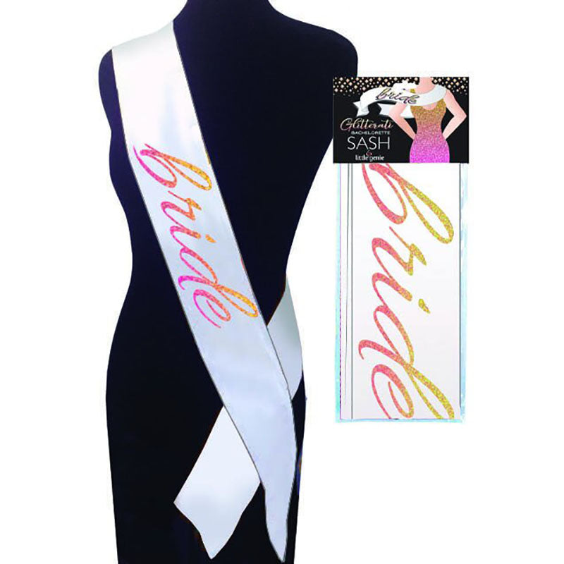 A mannequin is adorned with the Glitterati - Bride Sash - Hens Party Novelty Sashy, showcasing the word "bride" in vibrant, glittery text. Beside the mannequin is the sash's packaging, which features a gradient of rainbow colors—ideal for a hens party celebration.