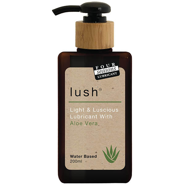 A brown bottle of Four Seasons Lush lubricant with a black pump dispenser and a wooden top. The label reads "Lush, Light & Luscious Lubricant With Aloe Vera Leaf Extract, Water-Based, 200ml," and features a green aloe vera plant graphic.