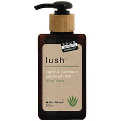 A brown bottle of Four Seasons Lush lubricant with a black pump dispenser and a wooden top. The label reads "Lush, Light & Luscious Lubricant With Aloe Vera Leaf Extract, Water-Based, 200ml," and features a green aloe vera plant graphic.
