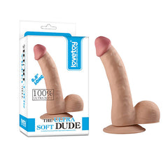 A realistic-looking beige dildo with a suction cup base is displayed beside its packaging box. The sleek, predominantly white packaging with blue accents highlights product details such as "100% Ultra Soft" and "8.0 inches long," and prominently features the product name: "The Ultra Soft Dude.