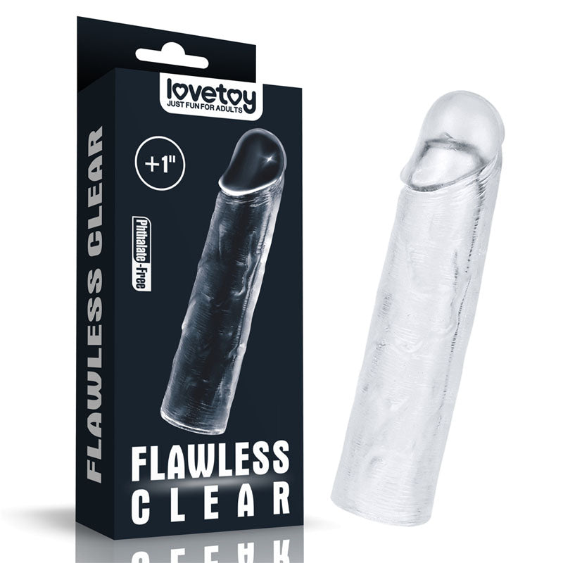 A clear silicone toy from the LOVETOY Shameless Clear series, named the Flawless Clear Penis Sleeve 1'' - Clear 2.5 cm Penis Extender Sleeve, sits beside its black packaging. The packaging prominently displays the brand name "lovetoy" along with the slogan "Just Fun for Adults," and includes the text "Flawless Clear," "+1 inch," and "Phthalate-Free." The super-realistic sculpted toy has a lifelike shape.