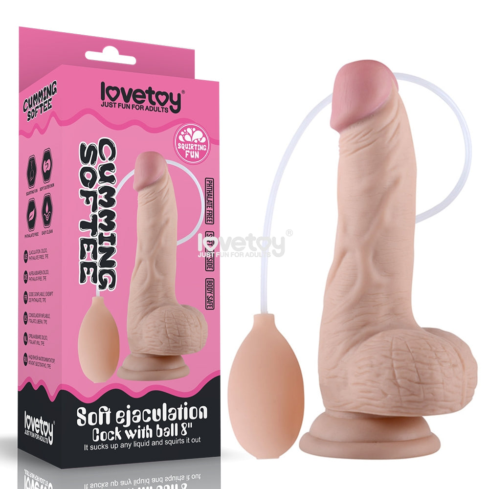 The Cumming Softee Soft Ejaculation Cock 8'' with Balls is an adult toy product featuring a realistic penis dildo with textured details and a suction cup base. It includes a squeeze pump for squirting fun, simulating ejaculation. The packaging is pink with product branding and illustrations, making it ideal when paired with water-based lubricant for enhanced pleasure.