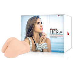 A product image features the "Kokos Real Hip Hera - Flesh Doggy-Style Masturbator." The package shows a woman with brown hair, wearing a white top and rope around her upper body, looking to the side. Next to the box is the small-hip masturbator in a skin tone color, designed with realistic lips for deep insertion.