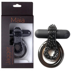 The "Maia Jagger - Black USB Rechargeable Vibrating Cock & Ball Ring" is featured alongside its packaging. The packaging, labeled "Maia," showcases the ring through a clear window. This waterproof ring includes a textured section for added stimulation and an attached slim pulsating vibrating component.