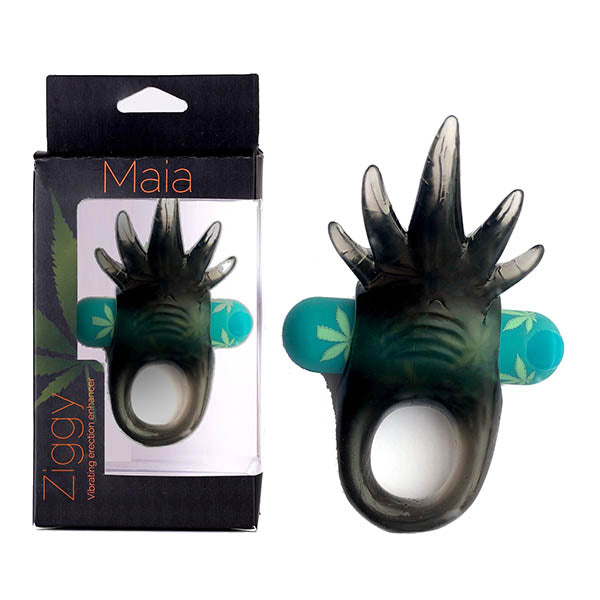 The Maia Ziggy Vibrating Cock Ring, packaged in a box labeled "Ziggy" and "Maia," is expertly designed for pleasure. This rechargeable vibrating erection enhancer boasts a black, spiky texture and a teal-blue component adorned with green leaves, ensuring heightened stimulation. Experience pulsating vibrations with the prominent circular ring at the base.