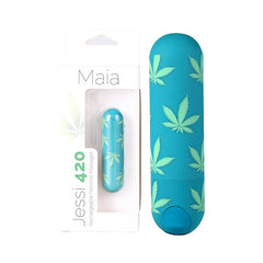An emerald green, mini bullet vibrator adorned with cannabis leaf patterns, placed next to its packaging box. The box features the brand name "Maia" and product name "Jessi 420," along with an image of the USB rechargeable, waterproof, and submersible massager.