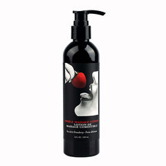 A black bottle of Edible Massage Lotion with a pump dispenser, labeled 'Strawberry' with an image of a strawberry and a human hand giving a massage.
