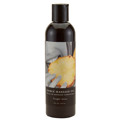 A black and white bottle labeled "Edible Massage Oil - Pineapple Flavoured - 237 ml Bottle" features an image of someone holding a slice of pineapple near their mouth. Highlighting "Pineapple" flavor, this vegan massage oil comes in an 8 fl. oz. / 237 mL size, perfect for a delightful and relaxing experience.
