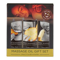 The Edible Tropical Massage Oil Trio features packaging with a relaxed woman on the top. It includes three 59 ml bottles of natural massage oil in Mango, Pineapple, and Banana flavors. The labels display close-ups of people savoring each fruit, and a "Hemp Seed Natural Body Care" seal is prominently placed on the top right to highlight its vegan skincare credentials.