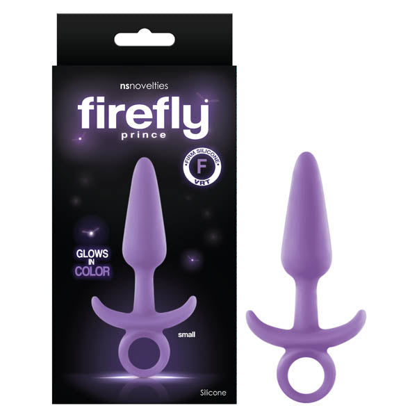 The image shows a Firefly Prince Butt Plug in purple, featuring a ring handle and flared base. It is presented next to its black packaging with purple text, highlighting "glows in color," "body-safe silicone," and "suitable for all lubricants." The product descriptions also mention assorted colors and sizes.