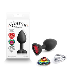 The Glams Xchange Heart - Small Black Butt Plug by NS Novelties is a fashionable accessory crafted from premium grade silicone for durability. It features a heart-shaped red gem base and comes with interchangeable colorful gems in both rainbow and clear options, perfectly packaged to highlight its place in the "Glams Xchange" line.