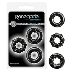 The image showcases a package for the Renegade - Dyno Rings Cock Ring, which includes three super-stretchy rings of different designs. The packaging indicates that the rings are made from TPE and prominently features the "nsnovelties" brand name at the bottom. Additionally, four performance-driven rings in assorted colors are displayed outside of the package.