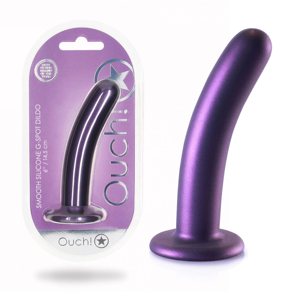 A purple OUCH! Smooth Silicone G-Spot Dildo - 6'' / 14.5 cm, featuring a curved shape and strong suction cup, is displayed next to its primarily white and purple packaging with "Ouch!" in bold letters. The packaging also has a transparent front, allowing the product to be seen clearly.