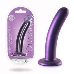 A purple OUCH! Smooth Silicone G-Spot Dildo - 6'' / 14.5 cm, featuring a curved shape and strong suction cup, is displayed next to its primarily white and purple packaging with "Ouch!" in bold letters. The packaging also has a transparent front, allowing the product to be seen clearly.