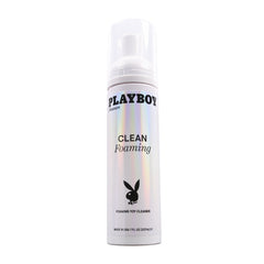 A white cylindrical container of "Playboy Pleasure CLEAN FOAMING" toy cleanser with a holographic sheen. The bottle features the Playboy logo, a bunny silhouette, and a pump dispenser on top. This gentle formula is 7 fl oz and labeled as "Made in USA.