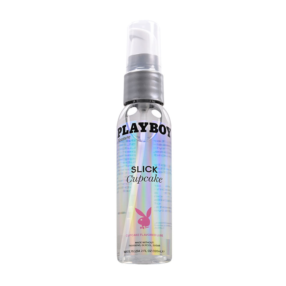 A clear bottle of Playboy Pleasure SLICK CUPCAKE Flavored Lubricant with an iridescent label and a white pump dispenser. The front features the text "Playboy" and "SLICK CUPCAKE," along with a pink Playboy bunny logo. This 60 ml water-based personal lubricant enhances natural lubrication for intimate sexual activity.