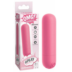 A pink silicone vibrator, named "OMG! Bullets #Play - Pink USB Rechargeable Bullet," is pictured next to its box. The box's stylish design features a pink and white color scheme. Notable features highlighted include 10 vibration modes, multi-functionality, USB rechargeability, silicone material construction, and waterproof capabilities.