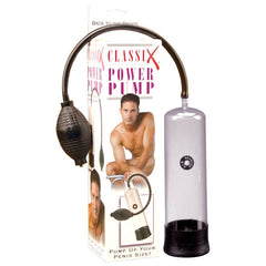 A clear cylindrical Classix Power Penis Pump with a black rubber bulb for manual pumping is displayed next to its packaging. The box showcases an image of a shirtless man kneeling, accompanied by the text "Classix Power Penis Pump" and "Pump up your penis size for the hardest erections!
