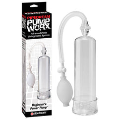 The image depicts a transparent plastic cylindrical Pump Worx Beginner's Power Penis Pump next to its packaging, labeled "Pipedream Pump Worx, Advanced Penis Enlargement System" and "Beginner's Power Pump." The pump includes a hose, a white hand-held bulb for generating suction, and a quick-release valve for convenient use.