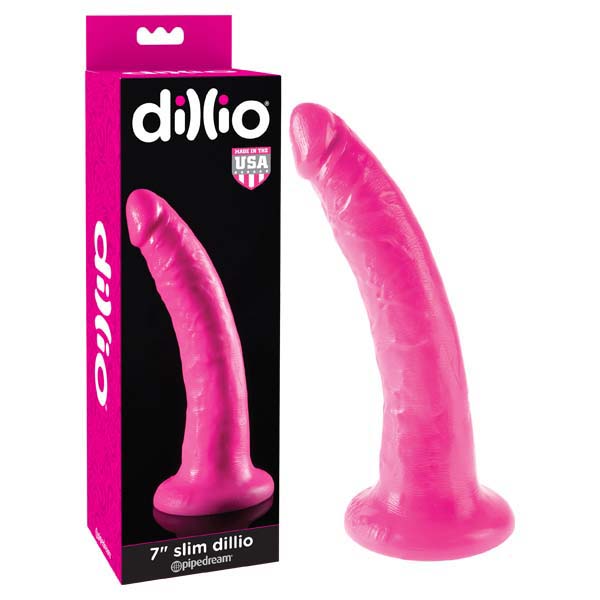 A Dillio 7'' Slim pink dildo with a suction-cup base is displayed next to its packaging. The Dillio packaging features an image of the dildo along with the brand name and a "Made in USA" label.